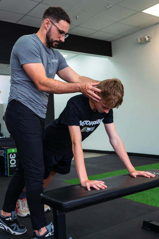 Patient working with a provider at a sports rehabilitation clinic in Springfield, MO during a return-to-sport exercise session
